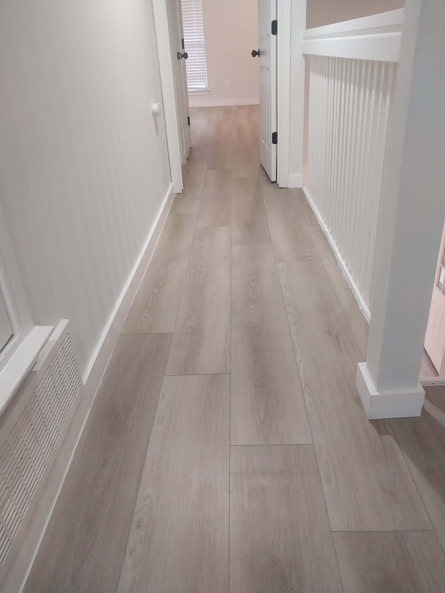 Light gray laminate flooring in hallway