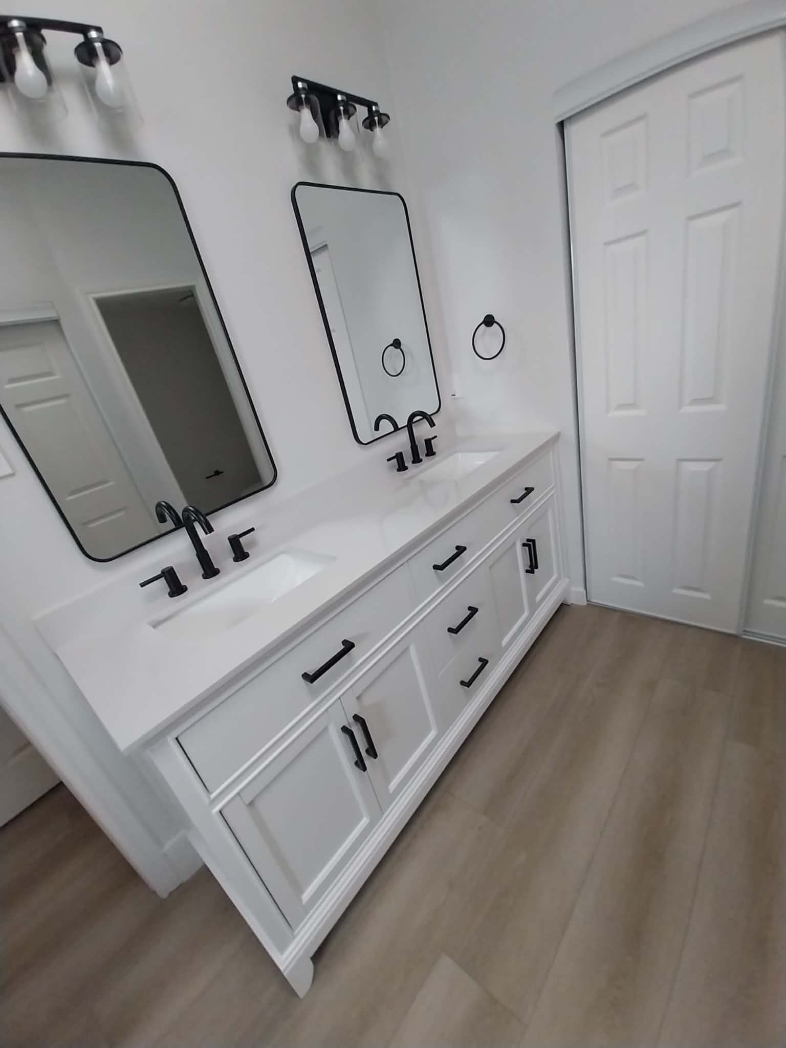 White double vanity bathroom with black fixtures