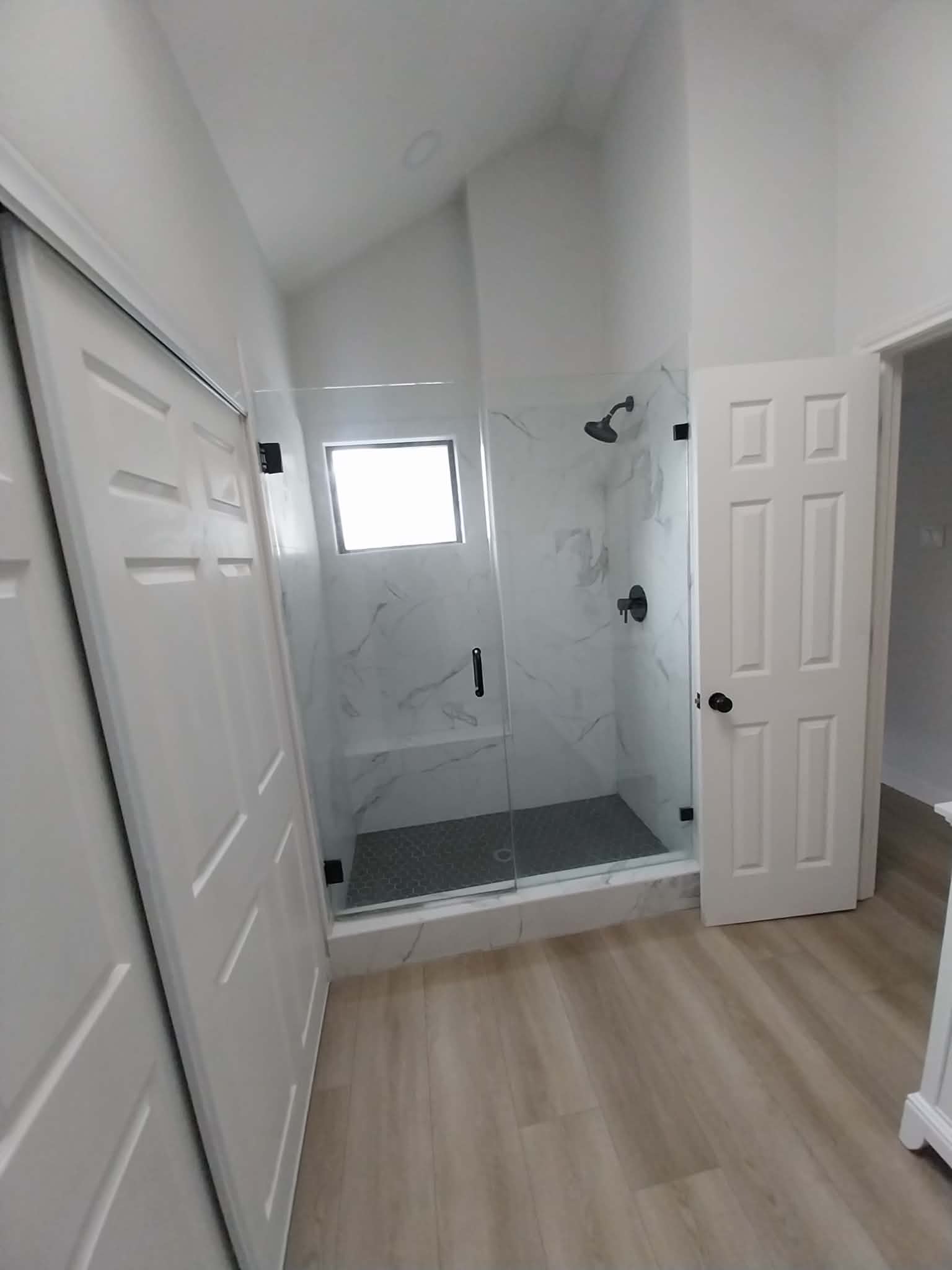 Bathroom with marble shower and glass door