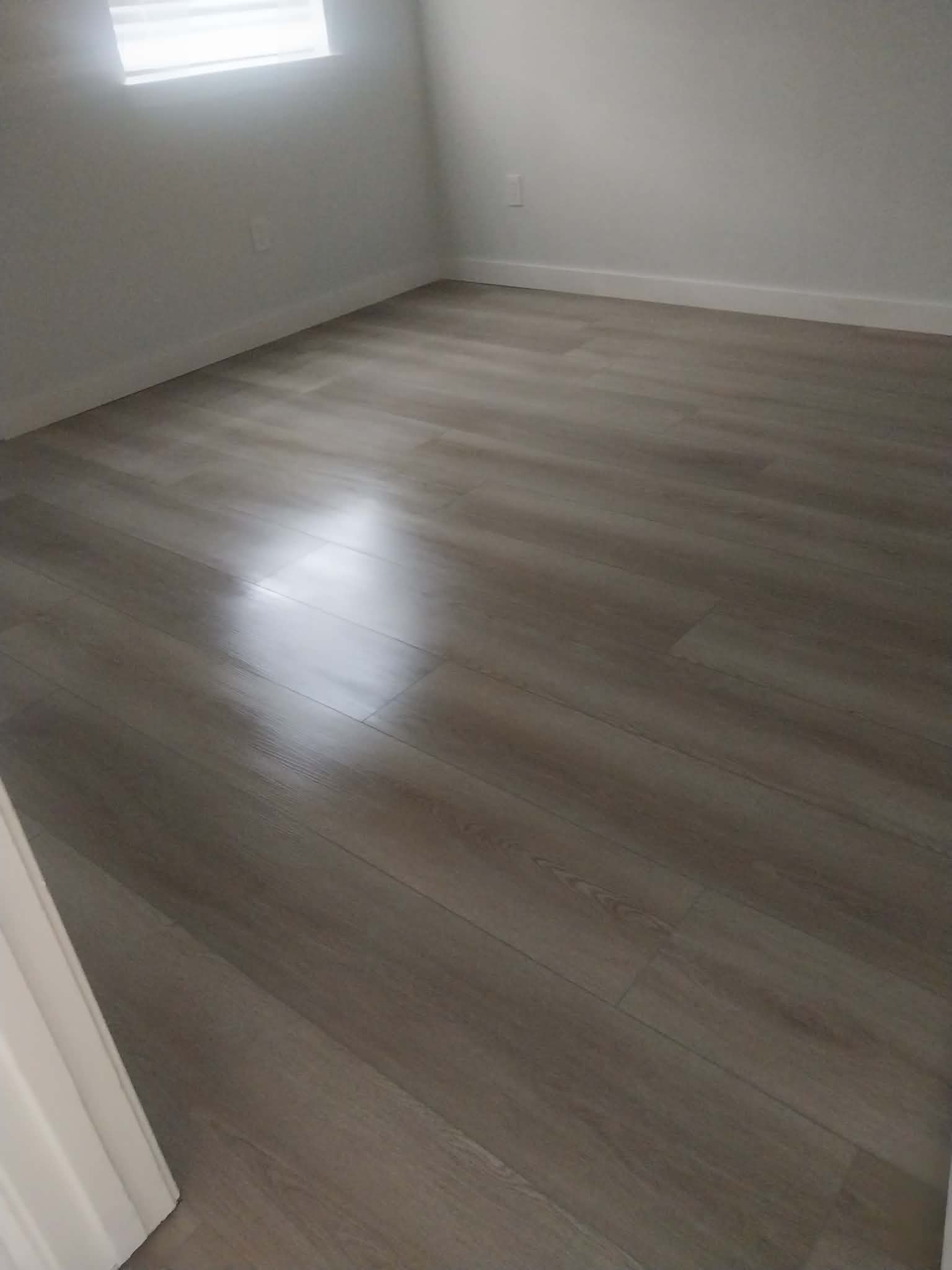 Gray laminate flooring in empty room