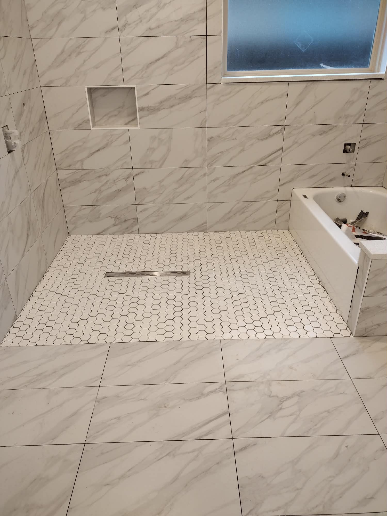 Marble bathroom with shower and bathtub